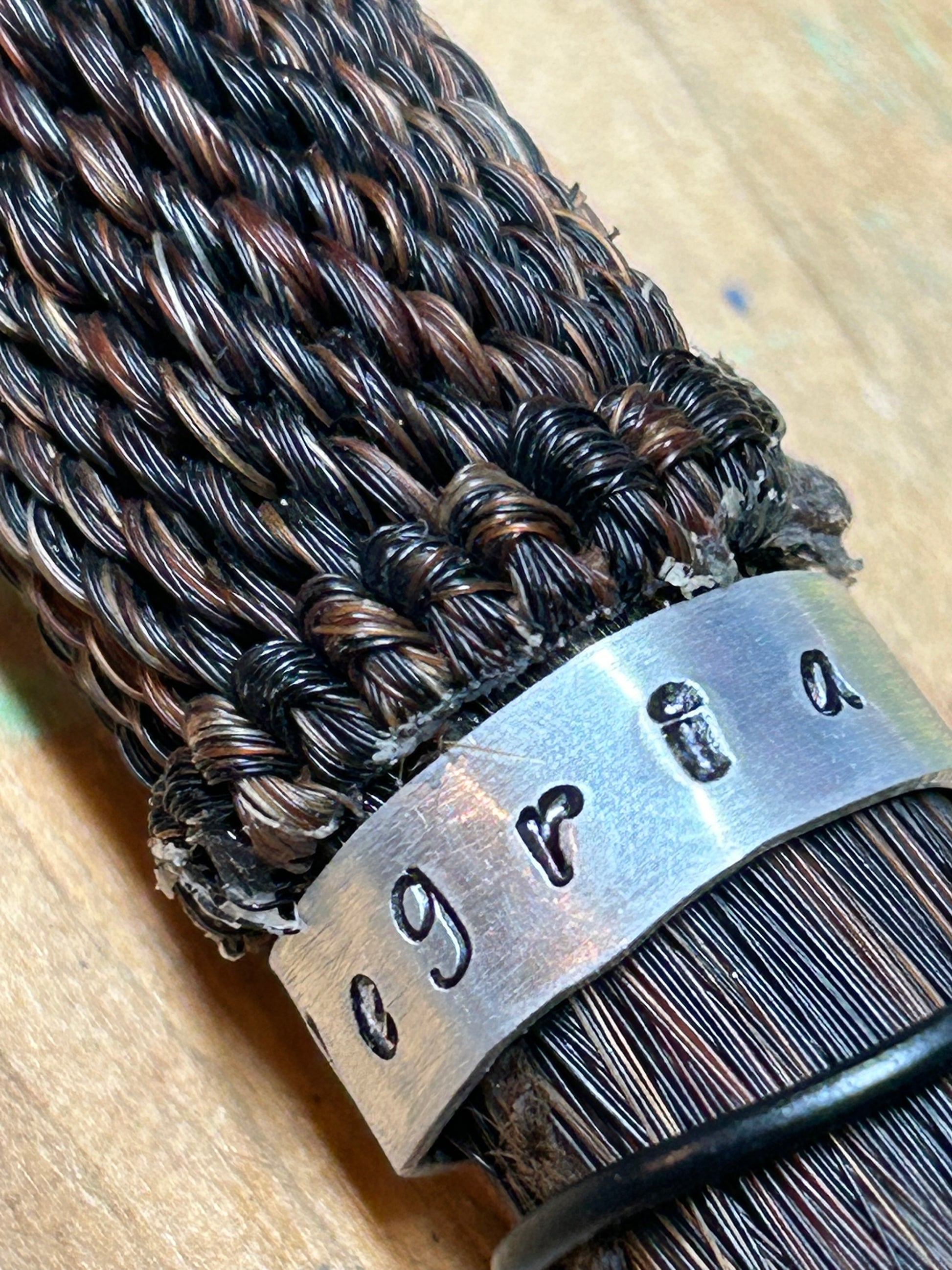 Close up of the horse hair tassel highlighting the metal name band.