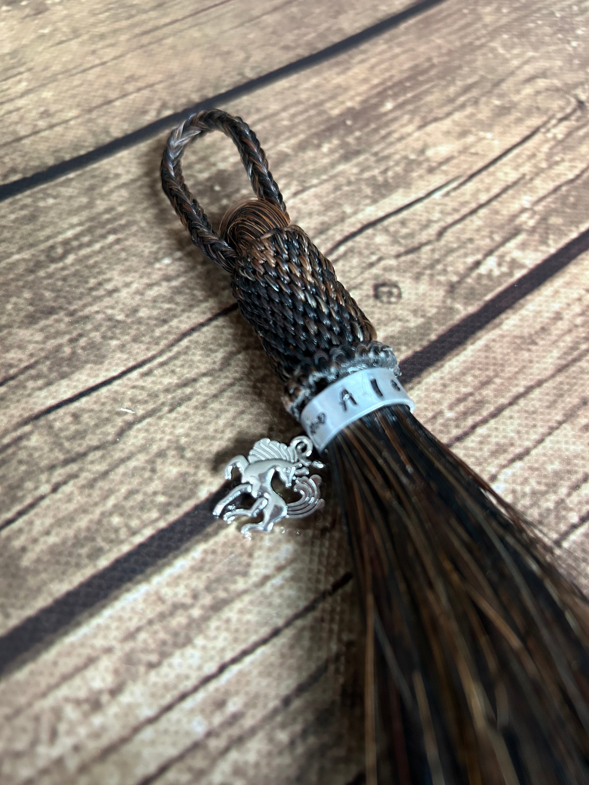 Horse hair tassel with charm.